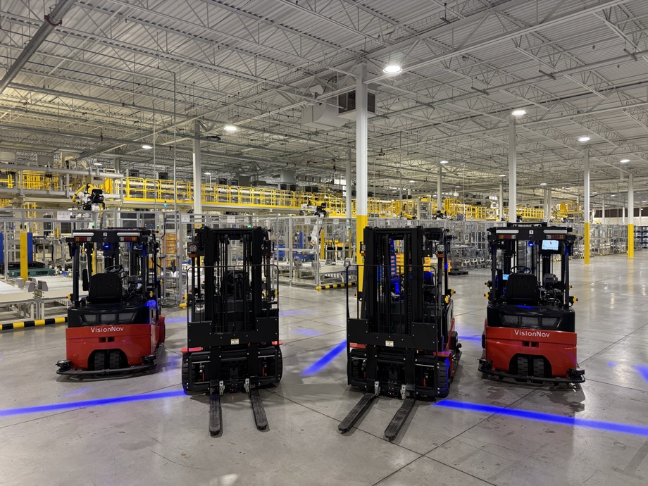 VisionNav autonomous forklifts lined up on a warehouse floor